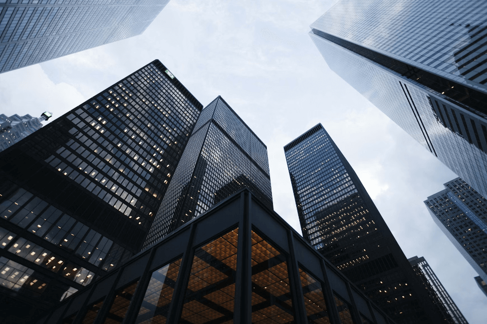 Skyscrapers are shown from the perspective of stood on the ground near the base of the buildings.