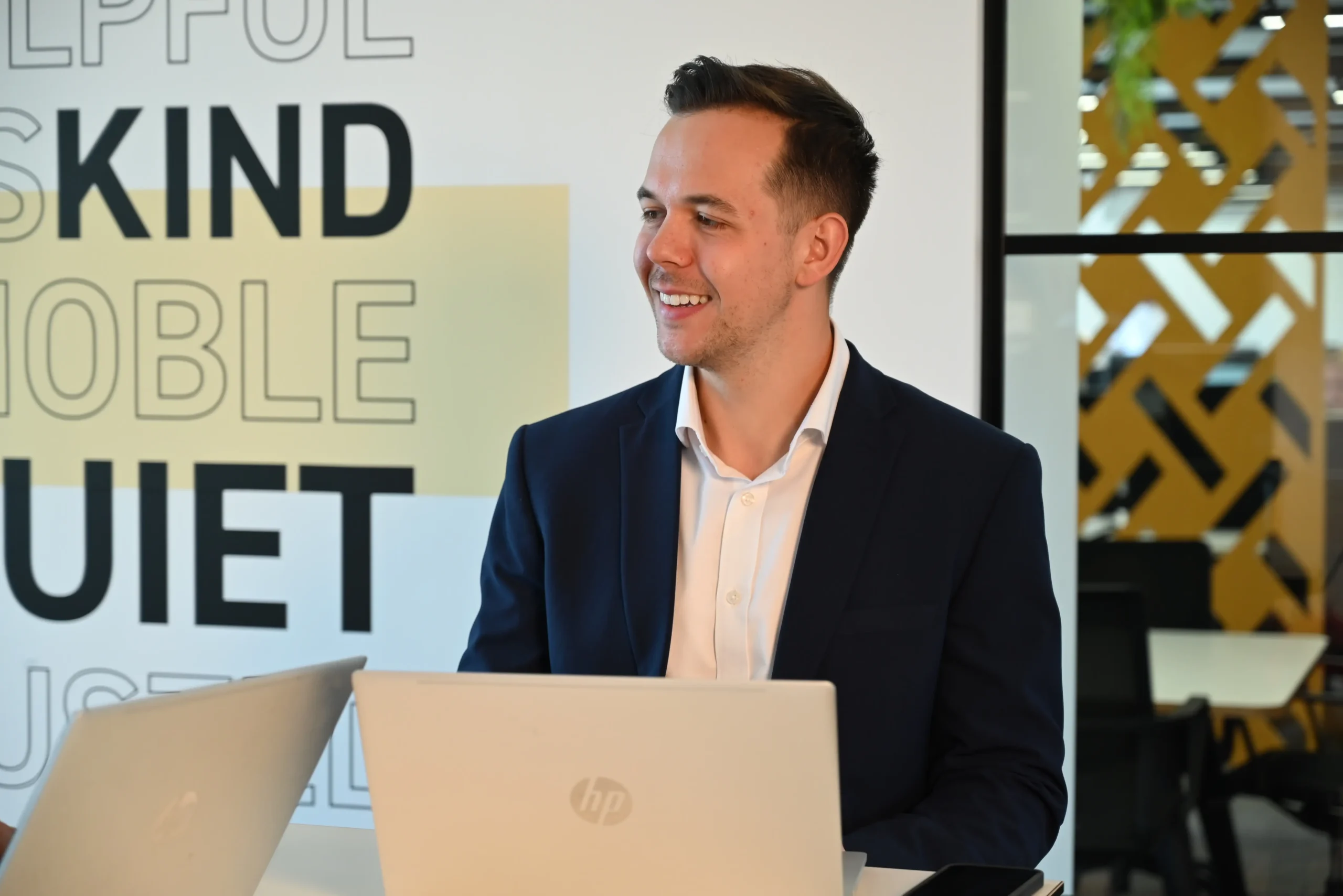 Russell Kaminski working on his laptop inside an office.